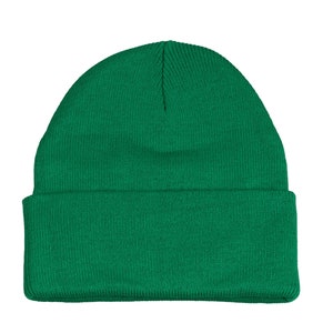 May include: A solid green beanie hat. The hat is made of a soft, knitted fabric.