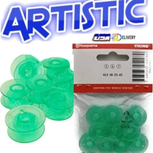 May include: Green plastic sewing machine bobbins. Some bobbins are stacked, and others are in a clear plastic package. The packaging includes the Husqvarna and Viking brand names, and the text "413 18 25-45". The word "ARTISTIC" is in the background.