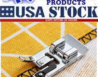 May include: A silver sewing machine foot on a yellow and white patterned fabric. The foot has a black and silver design. The image includes the text "ARTISTIC PRODUCTS USA STOCK".