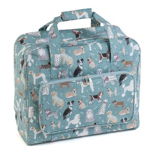 May include: A teal tote bag with a repeating pattern of different dog breeds and bone shapes. The bag has a zipped front pocket, a top handle, and a shoulder strap. The bag is designed for carrying items.