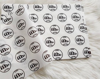 May include: White tissue paper with a repeating pattern of black and white zebra print shoe logos with the text "Zebra Customs".