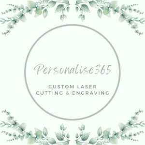May include: A light green and white graphic with the text "Personalise365" inside a gray circle. The text "CUSTOM LASER CUTTING & ENGRAVING" is below. The image is framed with watercolor eucalyptus leaves.