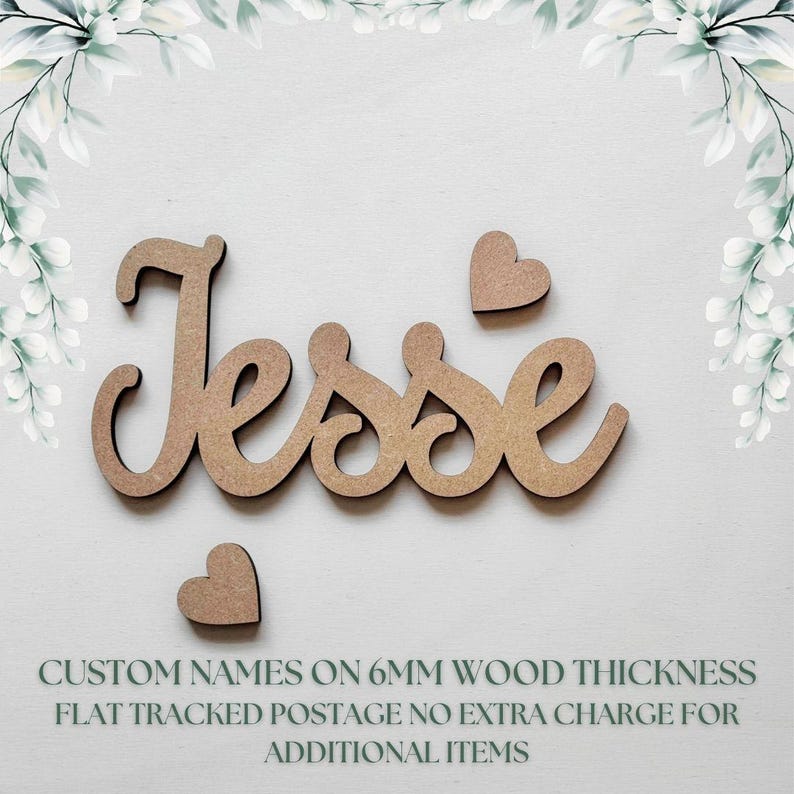 May include: Wooden name "Jesse" with two heart accents. The name is in a cursive font. The text at the bottom says "CUSTOM NAMES ON 6MM WOOD THICKNESS". The name and hearts are a light brown color.