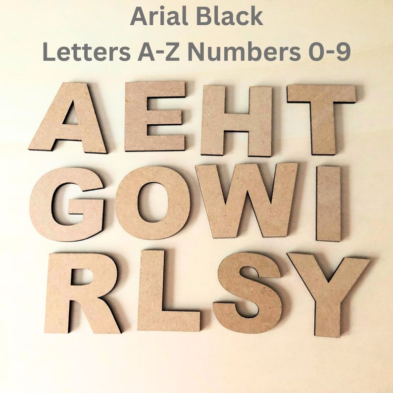 May include: A set of tan, flat, cut-out letters in the Arial Black font style. The letters displayed are A, E, H, T, G, O, W, I, R, L, S, and Y. The text at the top reads Arial Black Letters A-Z Numbers 0-9, indicating available options.