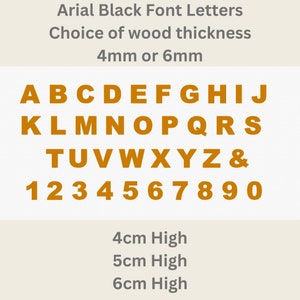May include: A set of orange Arial font letters, numbers, and an ampersand symbol. Text includes: Arial Black Font Letters, Choice of wood thickness 4mm or 6mm, 4cm High, 5cm High, 6cm High. The characters are arranged in rows on a light background.