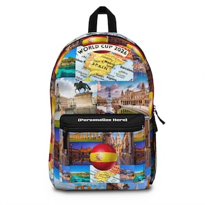 May include: A backpack featuring a collage of Spanish landmarks, a map of Spain, and a football with the Spanish flag. The top displays the text WORLD CUP 2026, and the front pocket features a black panel with the text (Personalize Here).