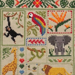May include: Cross-stitch sampler featuring a jungle theme. The design includes a monkey, parrot, giraffe, snake, elephant, and lion. The border has floral and leaf patterns. The color palette includes green, red, yellow, and blue.