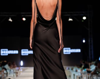 Maxi elegant black dress with draped neckline and draped back. Back is decorated with beads of black crystals. Adjustable straps.