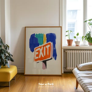 May include: A framed rectangular art print featuring an orange rectangular sign with the word EXIT in white capital letters. The sign is set against a background of abstract blue, teal, and yellow brushstrokes on a white surface.
