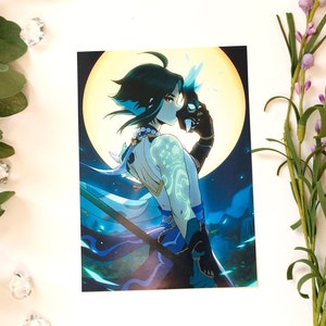 May include: Art print featuring a teal-haired character with a mask, set against a full moon. The artwork has a fantasy theme, with a detailed illustration style and a color palette of teal, blue, and black. The print is surrounded by eucalyptus and floral accents.