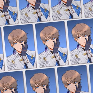 May include: A collection of rectangular cards featuring an anime-style illustration of a character with light brown hair and blue eyes. The character wears a white jacket with blue accents, dark gloves, and long, dangling purple and blue earrings.