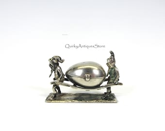 Antique Continental silver dwarves or gnomes carrying an egg figural thimble holder with thimble