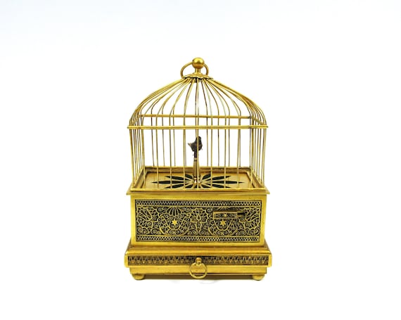 Jouet vintage mécanique en tôle imprimée polychrome oiseau