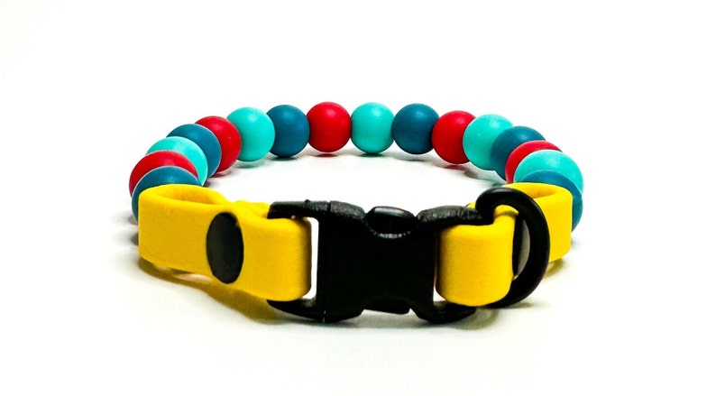 Breakaway bead cat collar made with dark teal, red and teal silicone beads paired with yellow biothane.