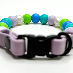 Breakaway bead cat collar made with pearl, lime green, light blue, teal and lilac silicone beads paired with lilac biothane