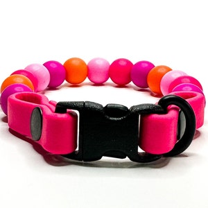 Breakaway bead cat collar made with fuchsia, light pink, orange, hot pink silicone beads paired with pink biothane.