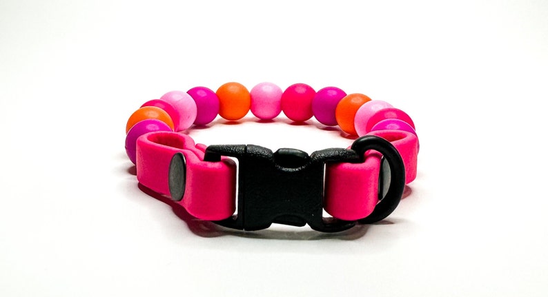Breakaway bead cat collar made with fuchsia, light pink, orange, hot pink silicone beads paired with pink biothane.