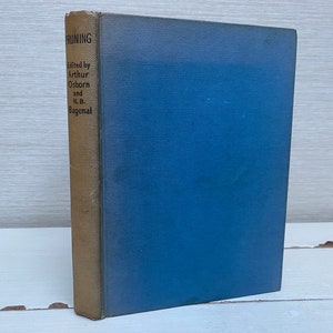 May include: A blue book with a gold spine. The spine has the text "RUNNING" and "Edited by Arthur Osborn and N.B. Bagenal".