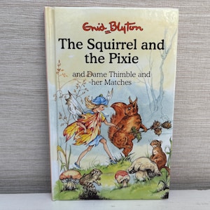 May include: A vintage children's book titled "The Squirrel and the Pixie" by Enid Blyton. The cover illustration features a fairy, a squirrel, and other woodland creatures in a colorful, whimsical scene. The book is in good condition.