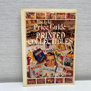 May include: A book cover with a colorful collage of vintage printed ephemera, including comic book covers, magazine covers, and advertisements. The title of the book is "The Lyle Price Guide to Printed Collectibles" by Tony Curtis.