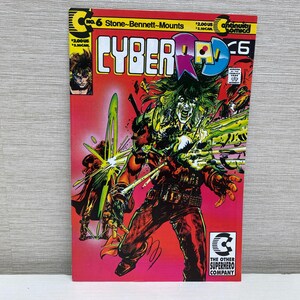 Peut inclure: Couverture de bande dessinée mettant en scène un personnage rouge, vert et noir avec une épée. Le titre de la bande dessinée est "CYBERAD" et le numéro du numéro est 6. La bande dessinée est publiée par "The Other Superhero Company".