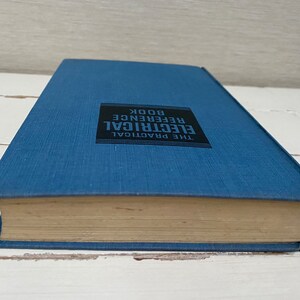 May include: A blue hardcover book with the title "The Practical Electrical Reference Book" printed on the spine.