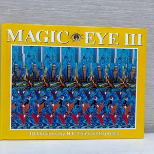 May include: A yellow book with the title "MAGIC EYE III" and the text "3D Illusions by N.E. Thing Enterprises". The cover features a blue and yellow 3D optical illusion.