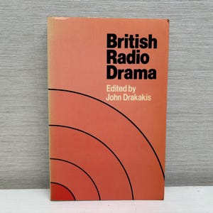 May include: A book titled "British Radio Drama" with an orange cover and black concentric circles. The book is edited by John Drakakis.