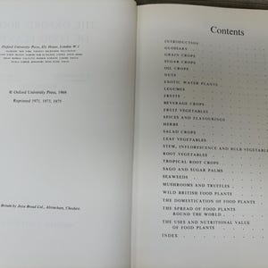 May include: Open book with the title "The Oxford Book of Food Plants" and a table of contents. The book was published in 1969 by Oxford University Press. The contents include topics like fruits, herbs, and root vegetables.