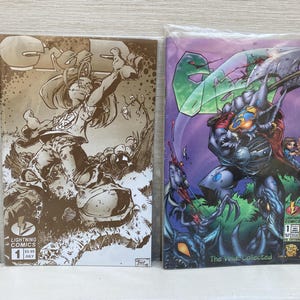 May include: Two comic books, both featuring the title "Crossed" in bold, white letters. The left comic book has a brown background with a black and white illustration of a person in a hooded jacket and trousers. The right comic book has a purple background with a black and white illustration of a creature with a large axe. The text "The World Collected" is printed on the bottom of the right comic book.