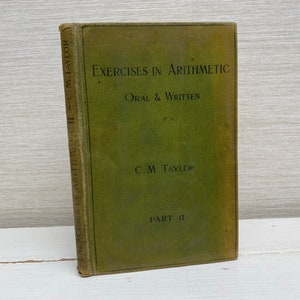 Może przedstawiać: Zielona książka zatytułowana "Exercises in Arithmetic, Oral & Written" autorstwa C.M. Taylora. Książka jest częścią II i ma zużyty, vintage wygląd.