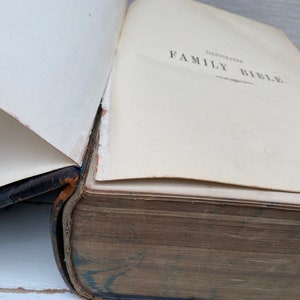 May include: A vintage, leather-bound book with the title "Illustrated Family Bible" on the cover.