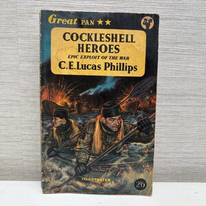 May include: Vintage paperback book titled "Cockleshell Heroes" by C.E. Lucas Phillips. The cover features an illustration of two men in a boat, with a war scene in the background. The book is published by Great Pan.