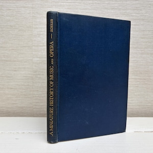 May include: A blue hardcover book titled "A Miniature History of Music and Opera - Schools".