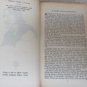 May include: Open book with text and a silhouette of a person on the left page. The right page features text about Robert Louis Stevenson. The book is printed in Italy.