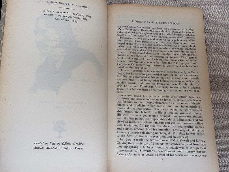 May include: Open book with text and a silhouette of a person on the left page. The right page features text about Robert Louis Stevenson. The book is printed in Italy.