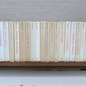 May include: A selection of Observer's books on a wooden shelf. Titles visible include "Birds," "Butterflies," "Wild Animals," and "Horses and Ponies." The spines are cream-coloured with red text. A classic series of pocket-sized reference books.