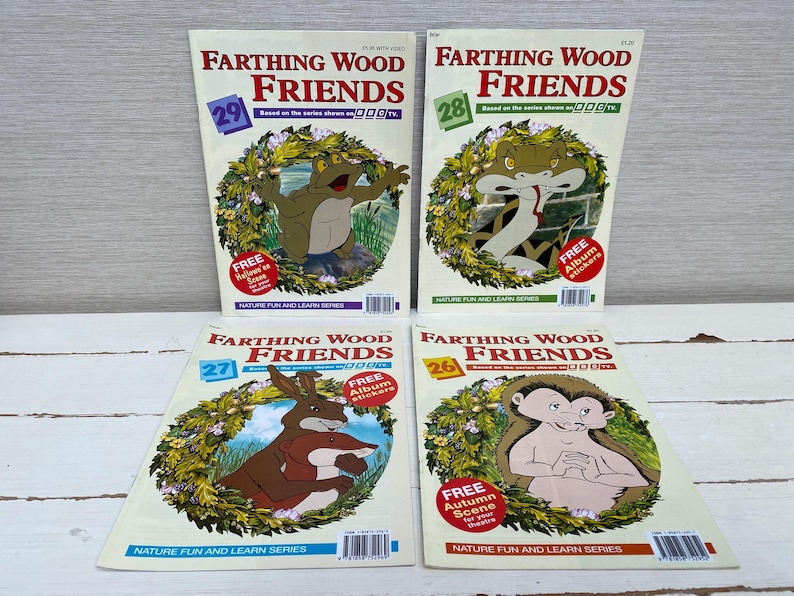 May include: Four colorful children's books featuring illustrations of animals from the Farthing Wood series. Each book has a different number, 26, 27, 28, and 29, and the title "Farthing Wood Friends". The books are all the same size and have a green and white background.