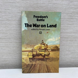 May include: A book titled "The War on Land" from the "Freedom's Battle" series, edited by Ronald Lewin. The cover features a painting of a tank driving through a field.