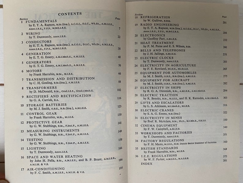 May include: A black and white book with the title "CONTENTS" printed on the cover. The book is open to a page with a list of sections and their corresponding page numbers. The sections include "Fundamentals", "Wiring", "Conductors", "Generation", "Generators", "Motors", "Transmission and Distribution", "Transformers", "Rectifiers and Rectification", "Storage Batteries", "Control Gear", "Protective Gear", "Measuring Instruments", "Testing", "Lighting", "Space and Water Heating", "Air-Conditioning", "Refrigeration", "Radio Engineering", "Electronics", "Heat Treatment", "Bells and Telephones", "Electric Clocks", "Electricity in Agriculture", "Equipment for Automobiles", "Equipment for Aircraft", "Electricity in Ships", "Electric Traction", "Lifts and Escalators", "Electric Cranes", "Electricity in Mines", "Cinema Equipment", "Workshops and Factories", "Factory Regulations", "British Standards", "I.E.E. Regulations", and "Index".
