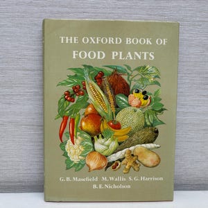 May include: A vintage book titled "The Oxford Book of Food Plants" with a green cover. The cover features a colorful illustration of various fruits and vegetables, including corn, tomatoes, and bananas. The authors' names are listed at the bottom.