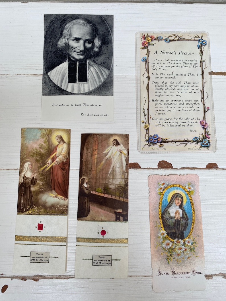 May include: Collection of vintage religious cards and bookmarks. Includes a black and white portrait, a prayer card with floral borders, and several bookmarks with religious imagery. The bookmarks feature gold accents and French text.