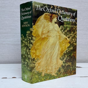 May include: A green hardback book with a gold title, "The Oxford Dictionary of Quotations, New Edition". The cover features a painting of a woman in a yellow dress standing in a field of flowers.