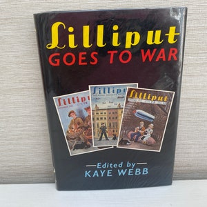 May include: A black hardcover book titled "Lilliput Goes To War" with three magazine covers on the front. The magazine covers are for "Lilliput" magazine and feature illustrations of people in wartime settings.