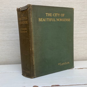 May include: A green hardcover book titled "The City of Beautiful Nonsense" by E. Temple Thurston. The book has gold lettering and is slightly worn.