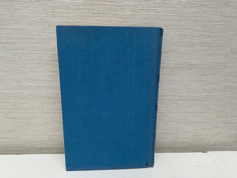 May include: A blue hardcover book with a plain cover.
