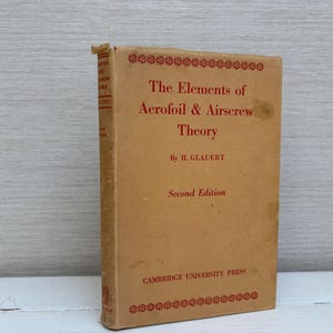 May include: A well-worn, tan-coloured book with the title "The Elements of Aerofoil & Airscrew Theory" by H. Glauert. The text is in red, and it's a second edition published by Cambridge University Press.