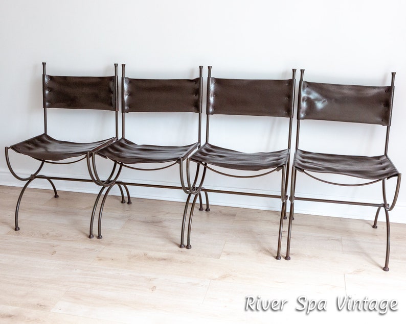 May include: Four brown leather chairs with metal frames. The chairs are arranged in a row and have a simple, rustic design.