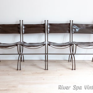 May include: Four brown leather chairs with metal frames. The chairs are arranged in a row and have a simple, rustic design.
