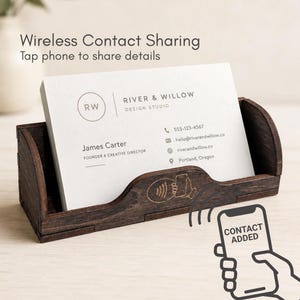 May include: A dark brown wooden business card holder containing white cards with the text River & Willow Design Studio, James Carter, and contact details. The holder features a laser-engraved icon of a hand holding a phone with signal waves.